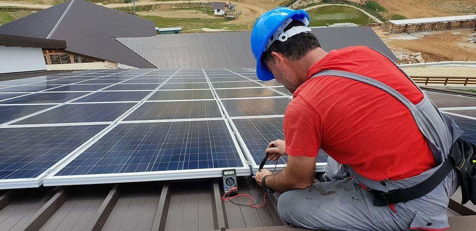Technician working on solar panel Technician working on solar panel