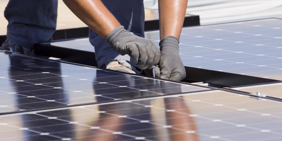 Hands Working on Solar Panel